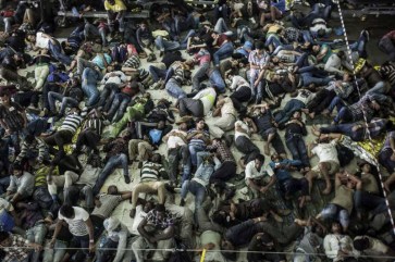 Asylum-seekers and economic migrants take to the seas, waiting out the dangerous journey in the boat’s cramped cargo space. Photo: UNHCR/A. D’Amato