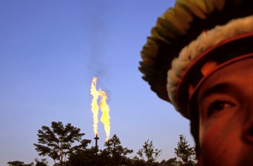 Chief Robinson, the leader of the Cofan Indians and a strong activist in the suit against Texaco. Photographed in front of the Guanta oilrig, Chief Robinson argues that the oil production has contaminated the river nearby as well as members of his community, who live down stream and several other parts of the region. He feels that « the government tries to convince us that oil is the future of Ecuador. The oil has only brought catastrophe here. We, the Cofan, are unanimous and determined to protect what is left of the forest. All of Mankind needs it. » | Author: 
