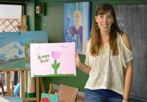 © UNICEF EAPRO/2014/Brown Celeste McGee holds a picture painted by Saeng at Dton Naam.