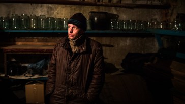  Nikolai grieves for his mother in a basement in Donetsk, Ukraine. | UNHCR/Andrew McConnell