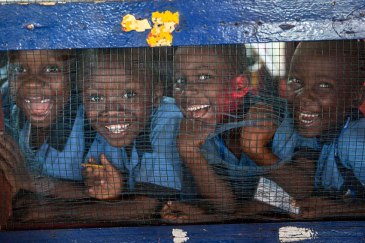 Grammar school students from the Herman Gmeiner High School in SOS Village, Matadi Estate, Monrovia, laugh at the photographer during an outreach event by UNMIL celebrating UN4U Day, in Liberia. Photo: UNMIL/Staton Winter