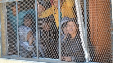 **Photo: Mathieu Galtier/IRIN | Women at a migrant detention centre in Surnam, Libya