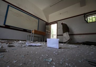 © UNICEF Yemen/2015 | A teacher walks in a damaged classroom of Ibn Sina School. Nevertheless, the need for greater public awareness only increases as the conflict deepens and expands to new areas.