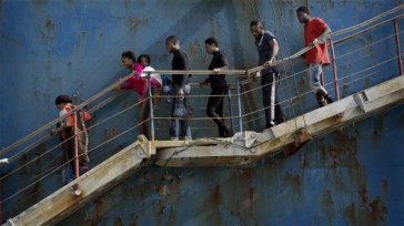 **Photo: Åsa Sjöström/IRIN | Migrants disembark at the Sicilian port of Catania after being rescued from a shipwreck by a merchant vessel on 5 May