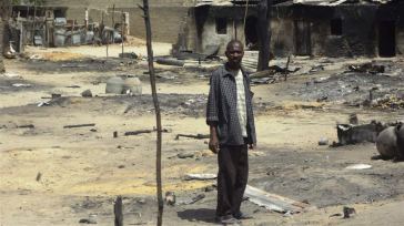 A man stands outside his destroyed home in Baga, Borno State, Nigeria, following heavy fighting between military forces from Nigeria, Niger and Chad, and Boko Haram. Photo: IRIN/Aminu Abubakar