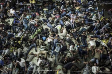 Asylum-seekers and economic migrants take to the seas, waiting out the dangerous journey in the boat’s cramped cargo space. Photo: UNHCR/A. D’Amato