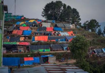 © UNICEF Nepal/2015/Sokol | Tents line a hillside in Charikot where families are now living after losing their homes.