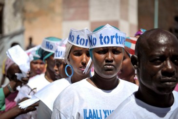 Singers wearing hats advocating “No Torture” line up before performing at a Human Rights Day event outside of Mogadishu Central Prison in Somalia on 10 December 2013. UN Photo/Tobin Jones