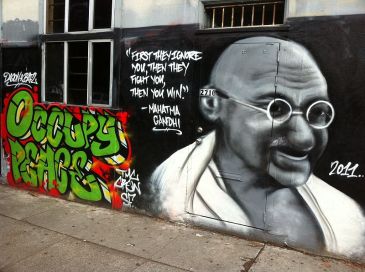 ***Image: A wall graffiti in San Francisco containing a quote and image of Gandhi | Author: Victorgrigas | 22 November 2011 | Wikimedia Commons