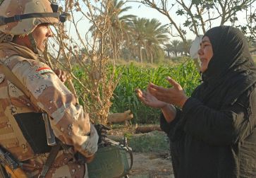 **Photo: A woman pleads to an Iraqi army soldier from 2nd Company, 5th Brigade, 2nd Iraqi Army Division to allow a suspected insurgent free during a raid near Tafaria, Iraq. | Author: U.S. Navy photo by Mass Communication Specialist 1st Class Jackey Bratt | Source: navy.mil | According to Wikimedia 