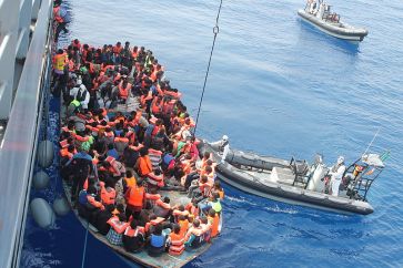 **Photo: Irish Naval personnel from the LÉ Eithne (P31) rescuing migrants as part of Operation Triton. | Author: Irish Defence Forces | Creative Commons Attribution 2.0 Generic license. | Wikimedia Commons
