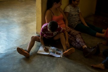 A boy works on his homework at the Todos posr Ellos family shelter in Tapachula