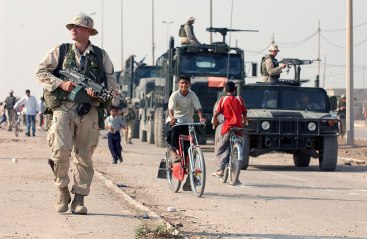 1024px-US_Navy_031016-N-3236B-043_A_marine_patrols_the_streets_of_Al_Faw,_Iraq